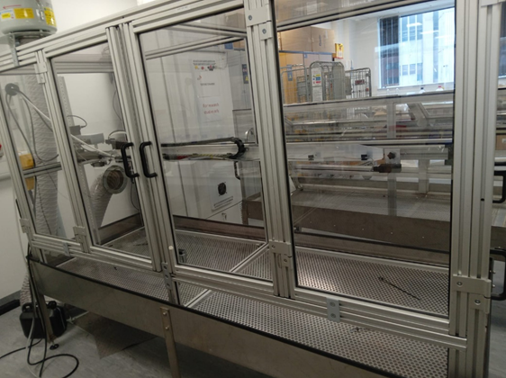 Large, floor to ceiling container with three large clear doors.
